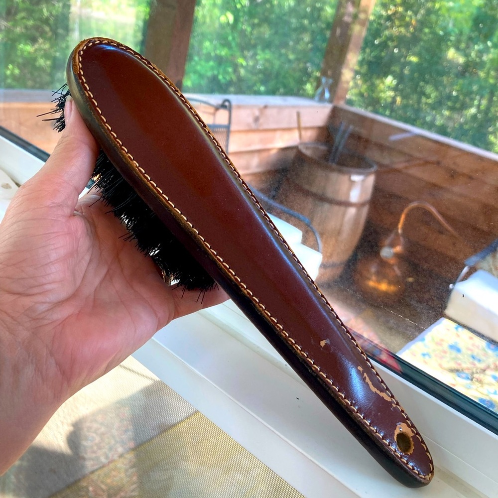 Mid century leather shoe brush. About a foot long.